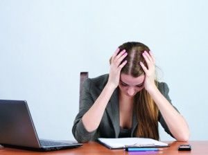 woman looking down at desk