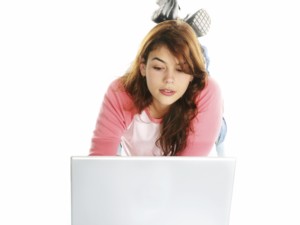 woman laying on floor on laptop