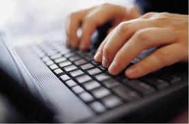 hands typing on laptop - close up